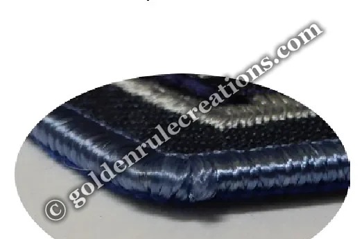Close-up of a merrowed, ravel-proof patch border — thread wrapped around the edge