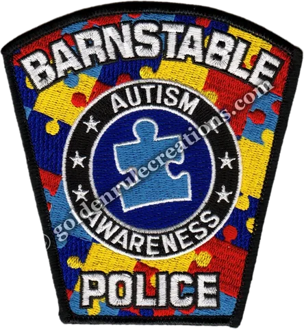 Police shoulder patch restyled with the autism-awareness puzzle pattern