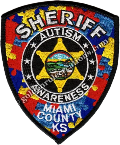 Sheriff's office patch restyled with the autism-awareness puzzle pattern
